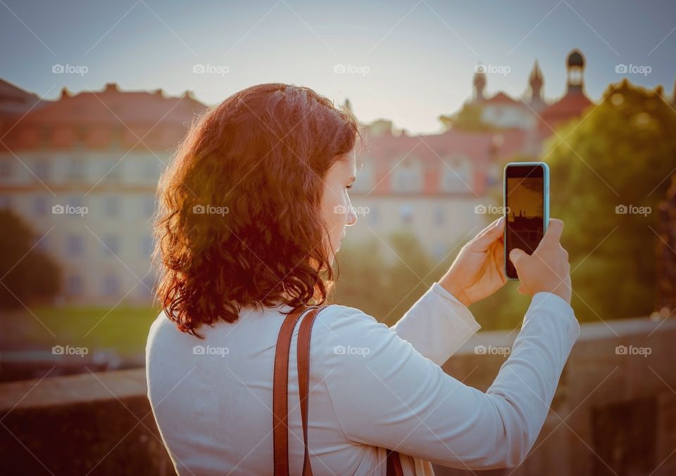 Woman taking photograph with mobile phone