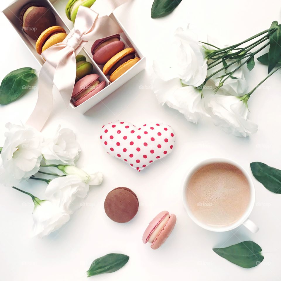 Cozy flat lay with cappuccino and macaroons