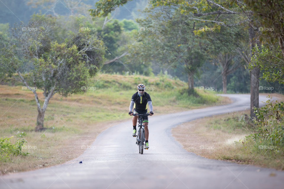 Tourist riding a bicycle in the forest 