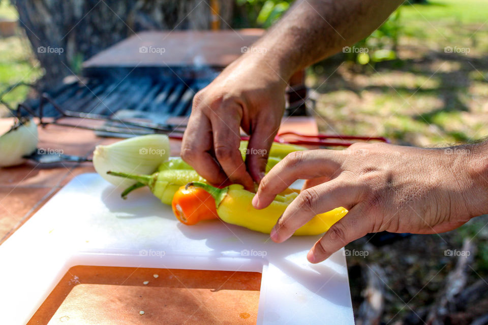 Stuffing peppers with cheese before grilling them