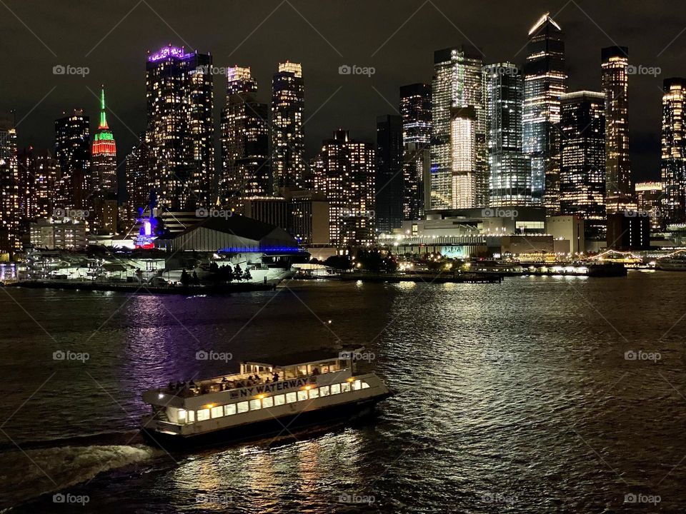 The New York City skyline at night viewed from the Hudson River