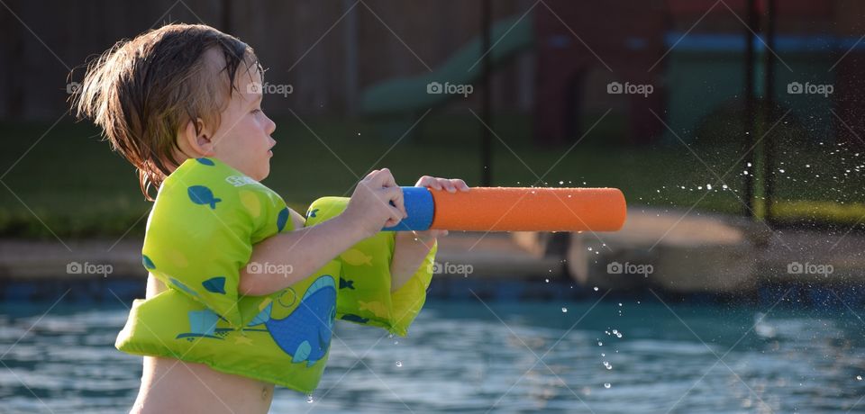 Child with armbands in swimming pool