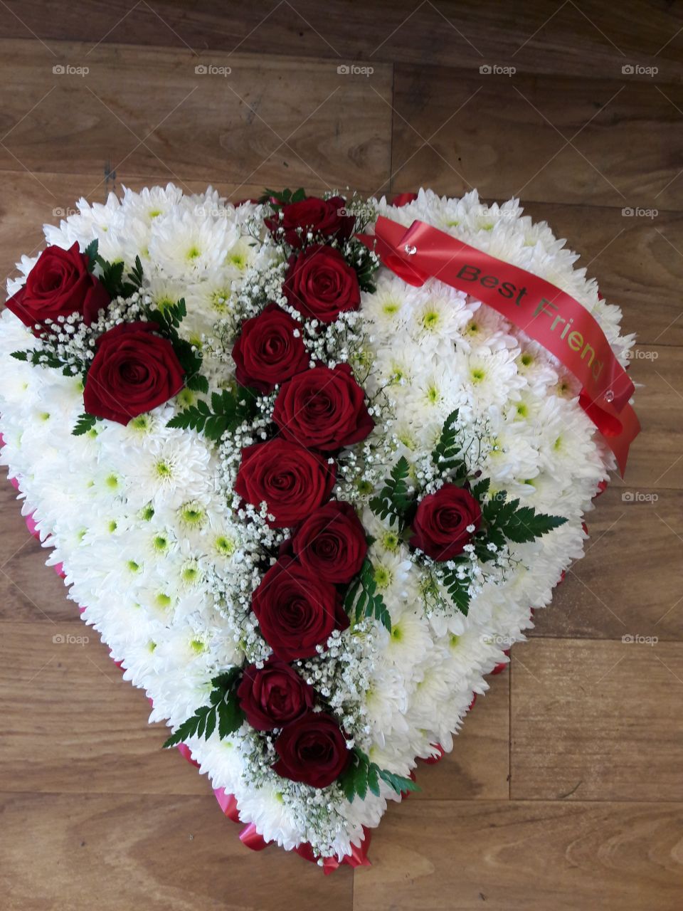 Heart funeral flower tribute with red roses