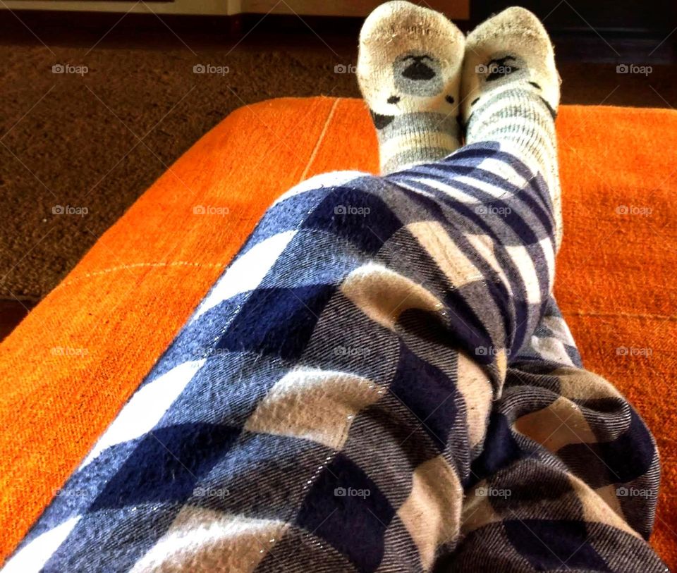 lounging in plaid pajamas and wool socks.