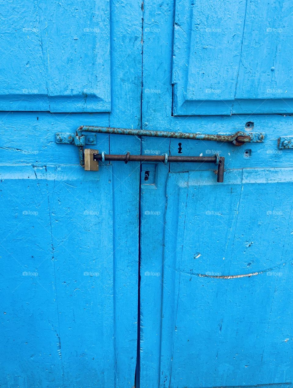 Blue brush painted wood door with lock 