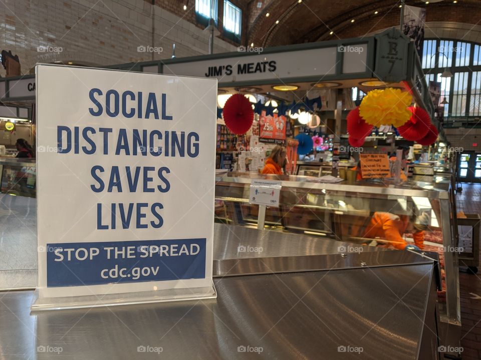 sign at Cleveland's West Side Market warning patrons to social distance.