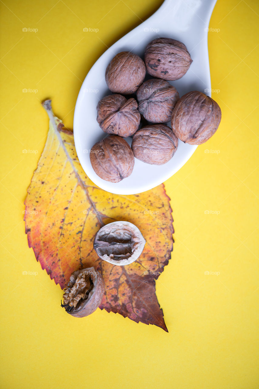 Walnuts on yellow