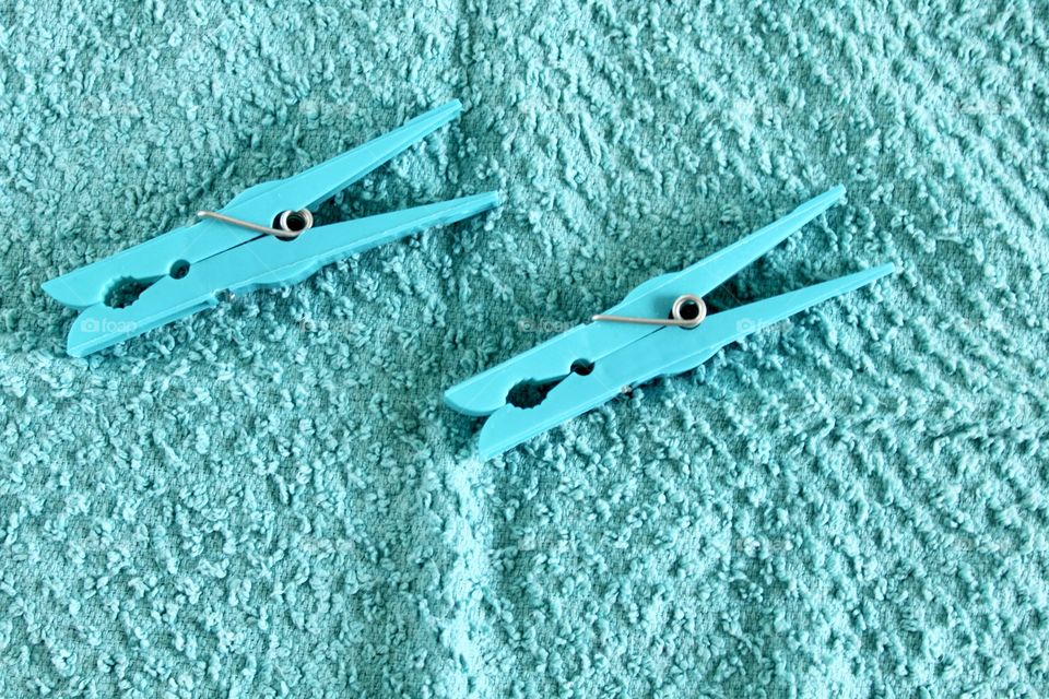 Blue clothespin on blue background