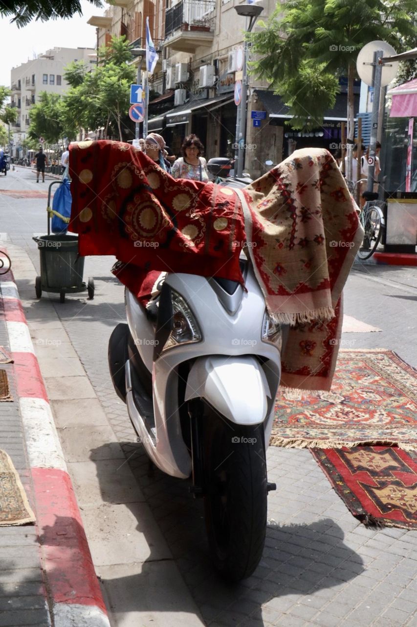 Motorcycle next to the carpet shop on market place