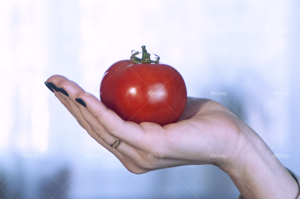 The girl is holding vegetables