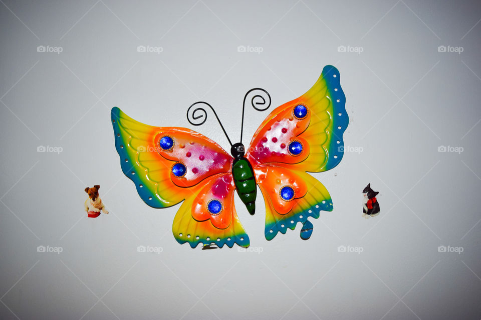 Colorful Beautiful Metal Butterfly. Metal artistic Butterfly. with a dog and cat on its sides