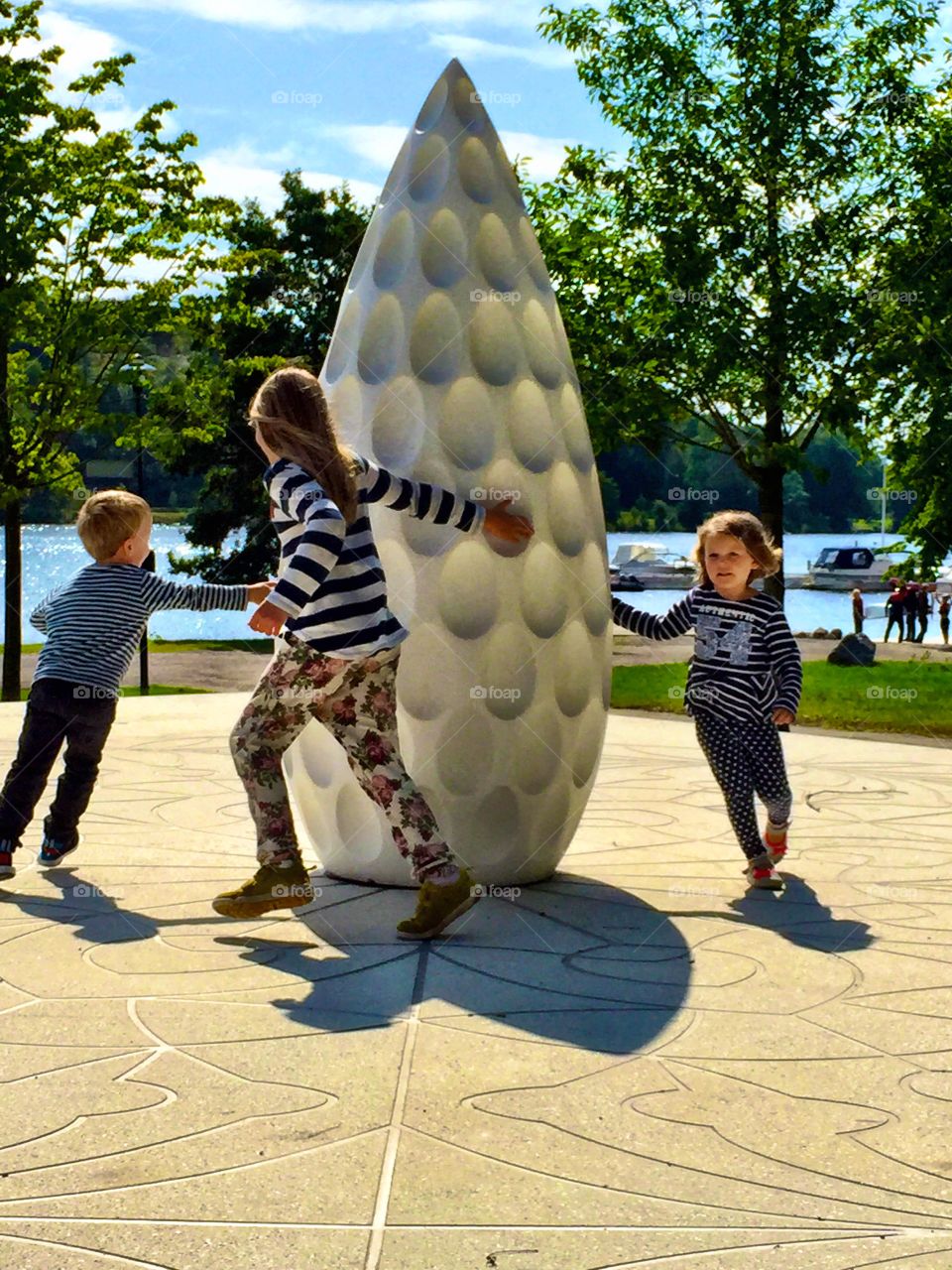 Brother and sister playing in park