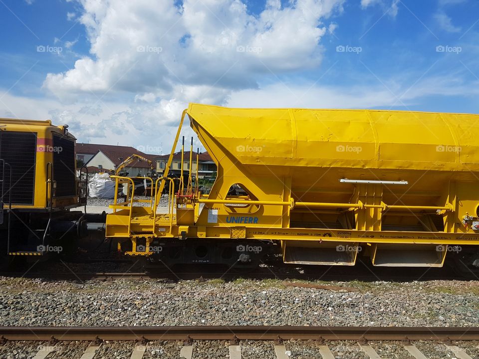 Yellow train vehicle on the railway station
