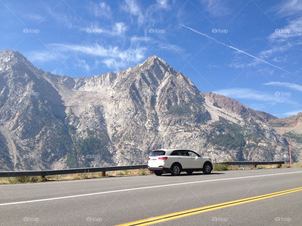 car parked in the Yosemite valley beside the mountains