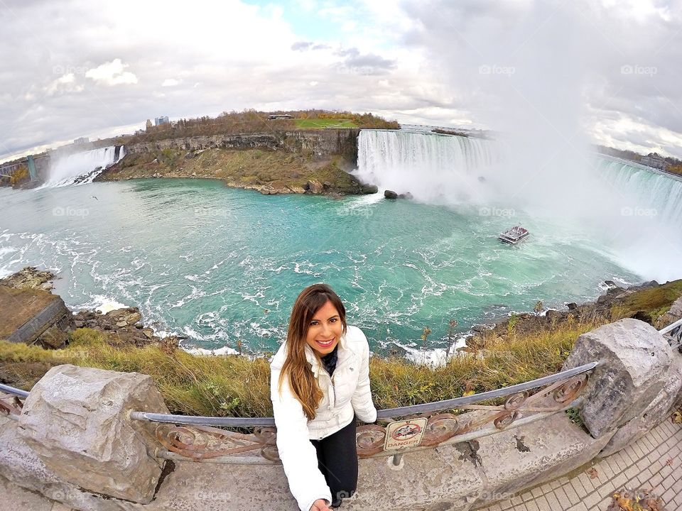 Woman taking selfie near waterfall