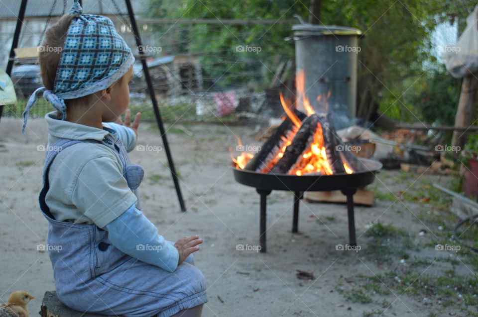 little boy by the fire