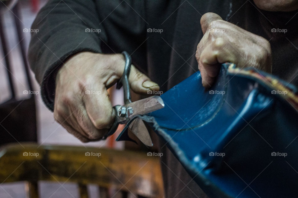 Close-up of a man cutting cloth