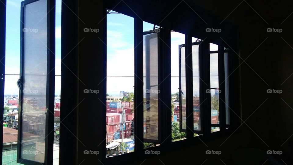 This is a picture of a window inside our school wherein you can clearly see the big containers used by shipping lines of the Cebu Port which is really near our school.