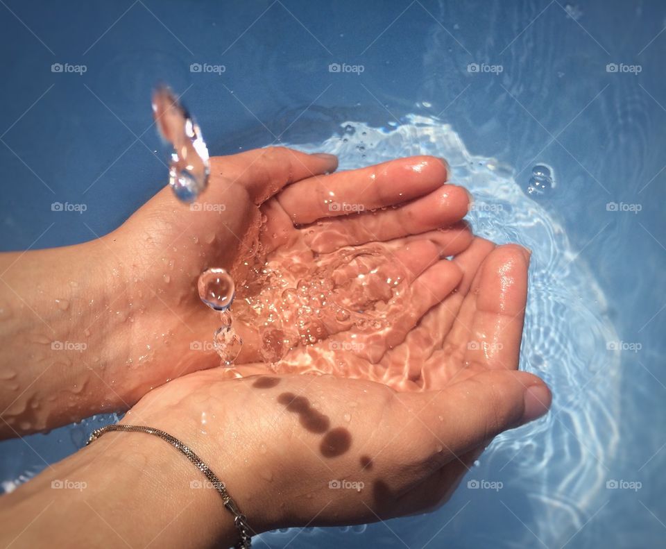 water and hands . hands holding water falling 