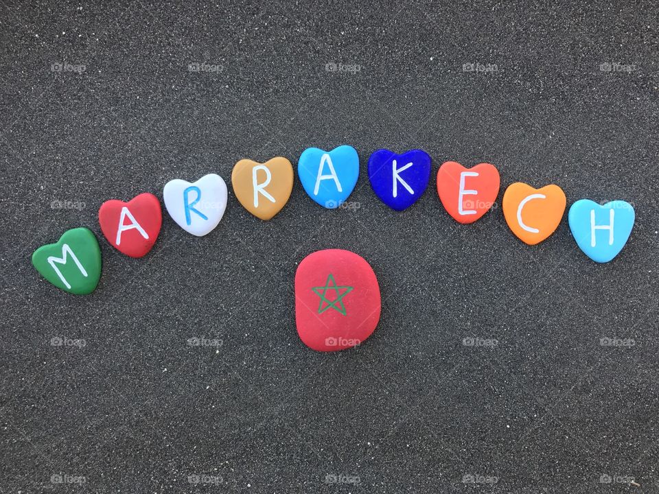 Marrakech, Morocco, with  colored heart stones over black volcanic sand