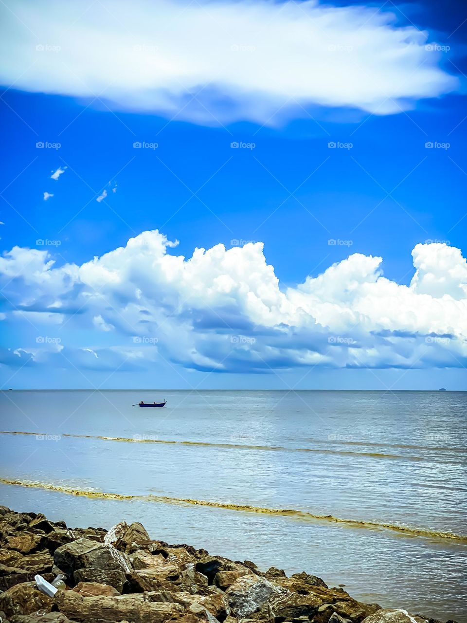 Beautiful fluffy clouds on a calm day at the beach in Northern Malaysia 
