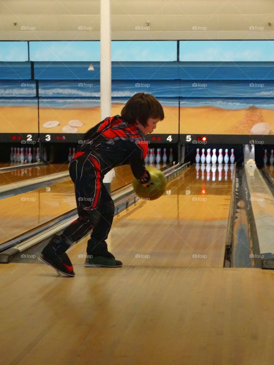 Boy Throwing A Bowling Ball