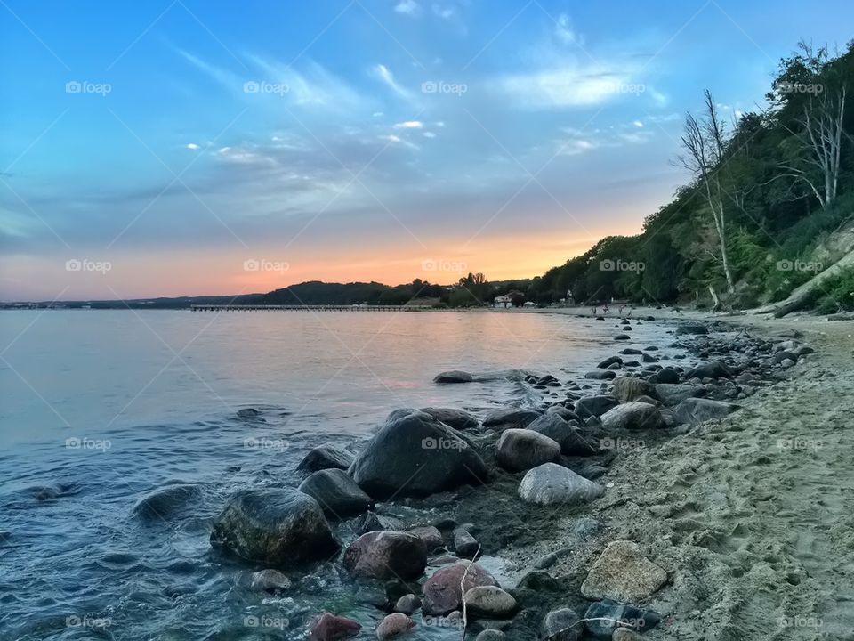 View of scenic beach at sunset