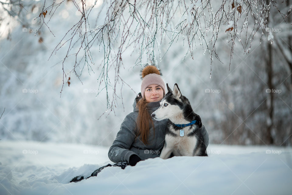 Walking with husky in winter park