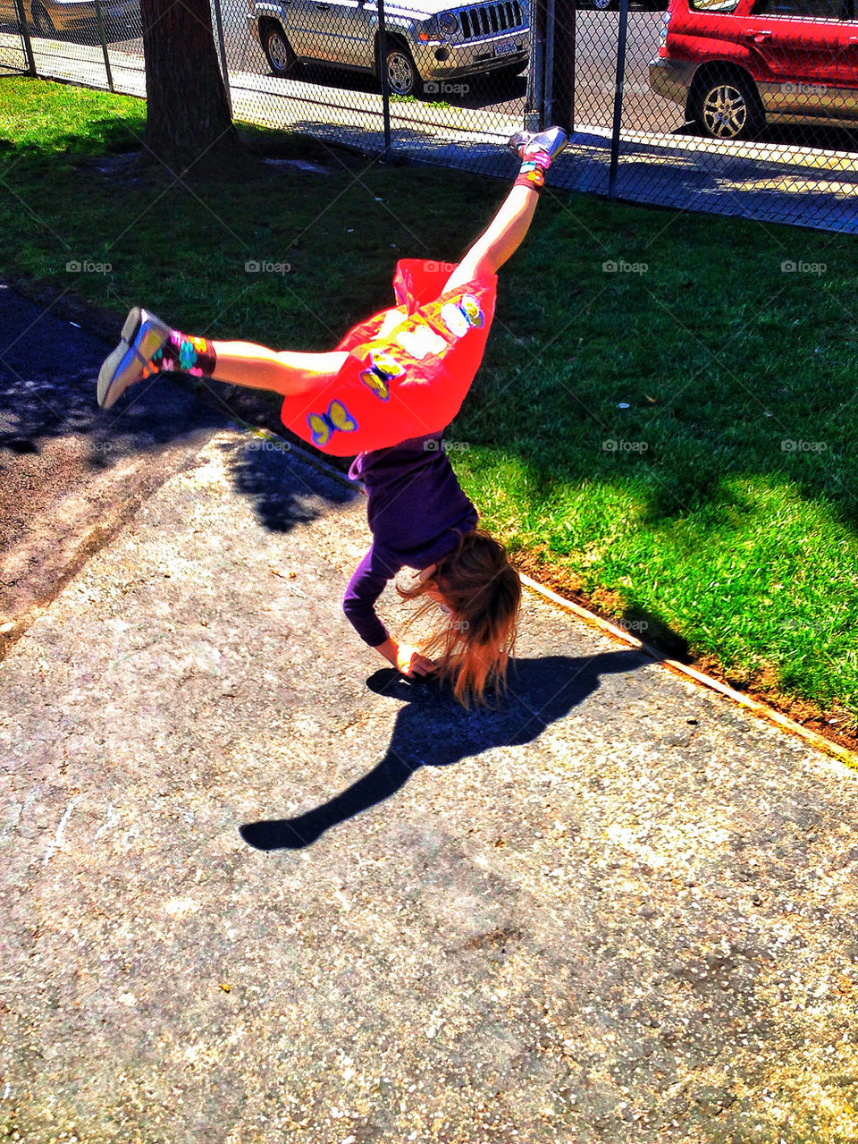 Young girl performing a cartwheel