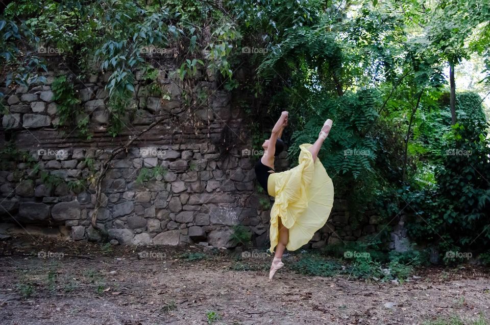 Young Female Ballerina Dancing Outside in Nature