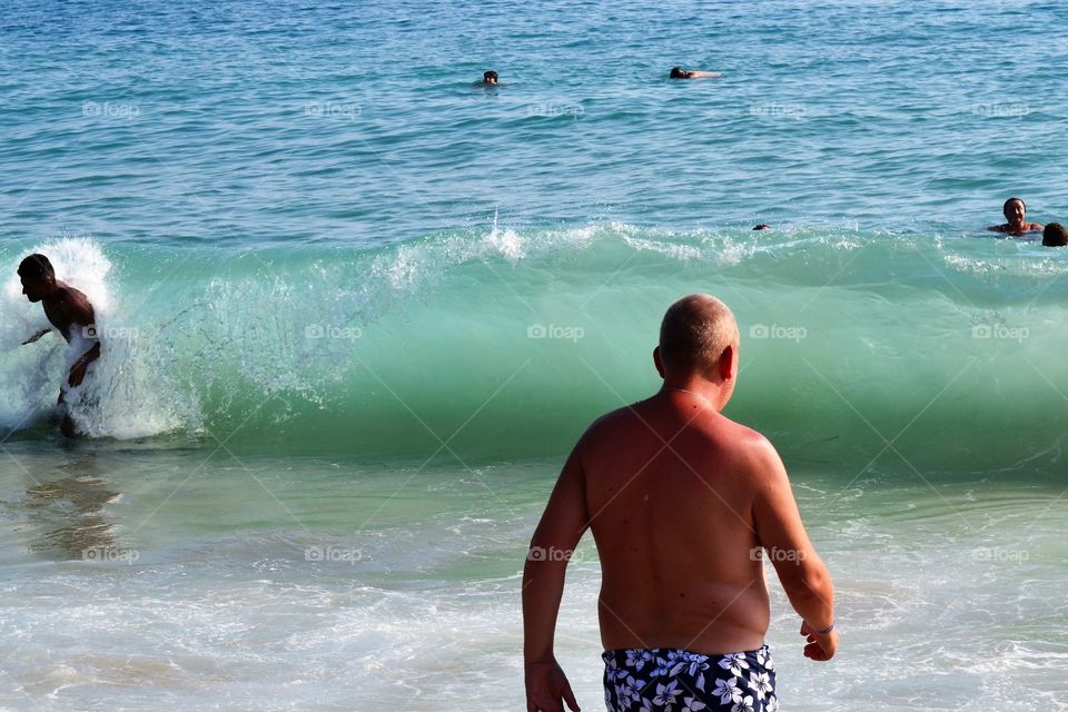 man entering the ocean