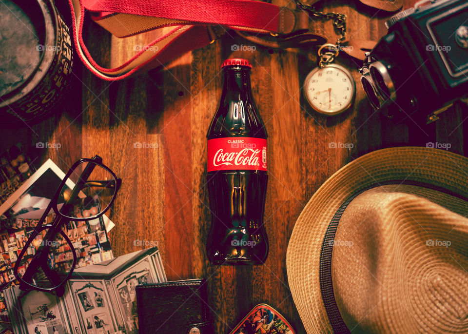 Vintage styled flat lay with a glass bottle of Coca Cola 