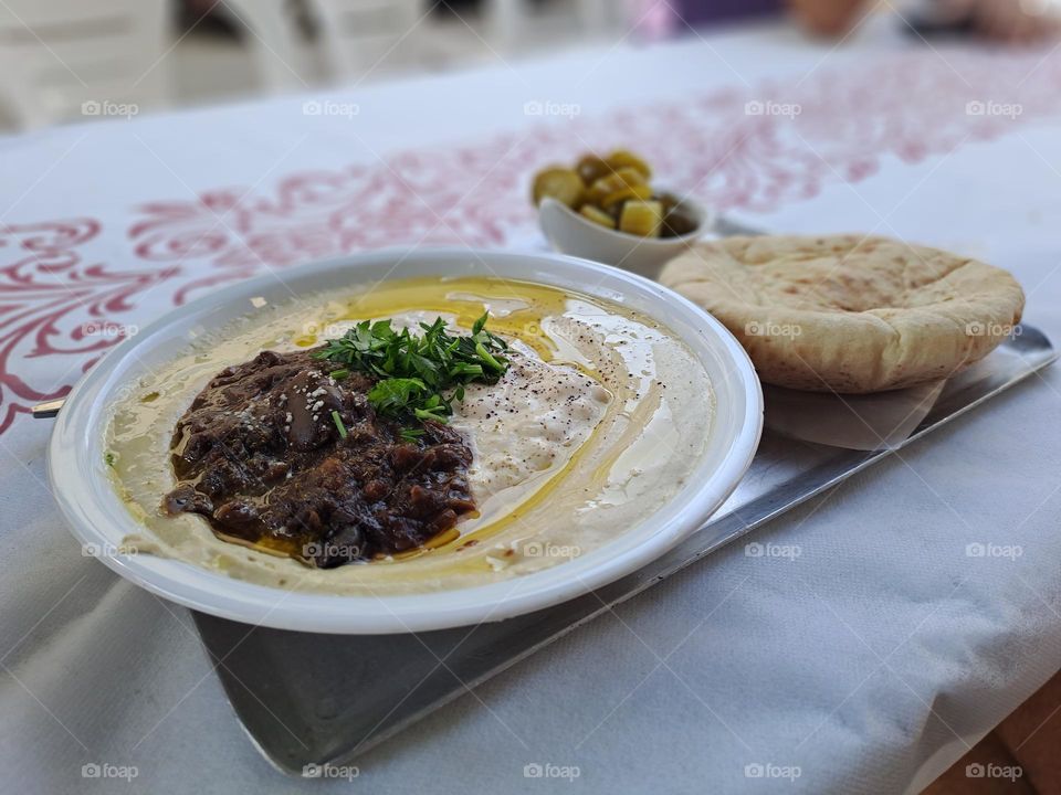 hummus plate with Tahini and cooked broad beans in Haifa