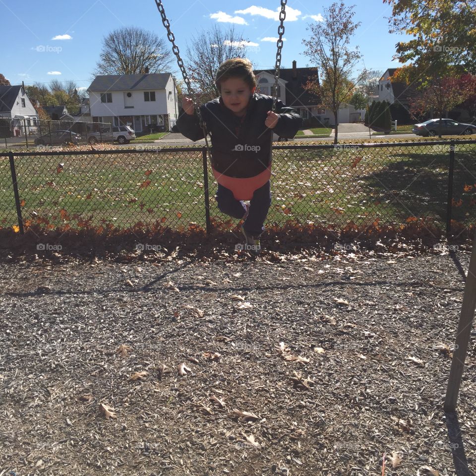 My son on the swings 
