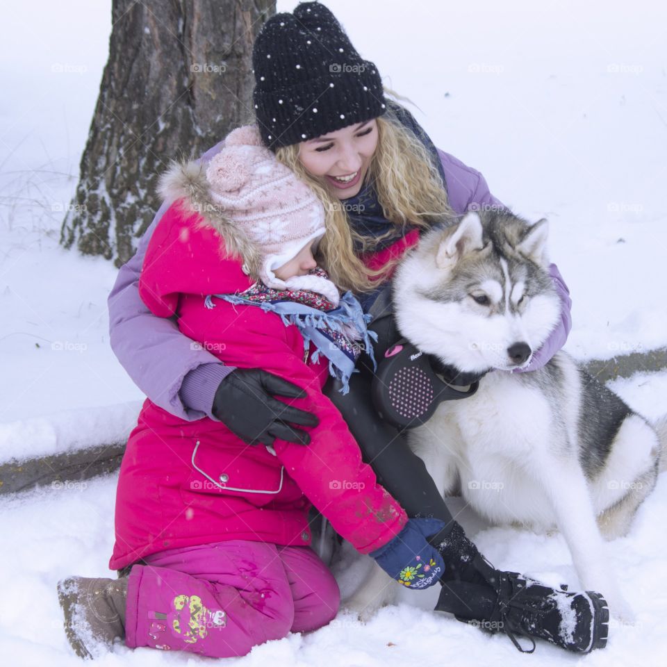 mother with daughter and dog husky