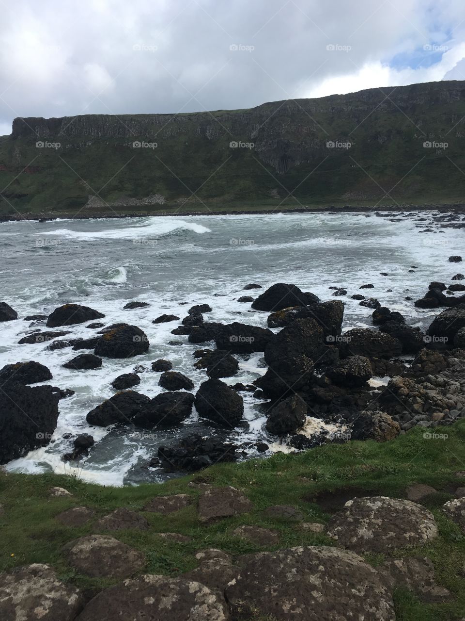 A rocky shoreline in Ireland on a rainy day 