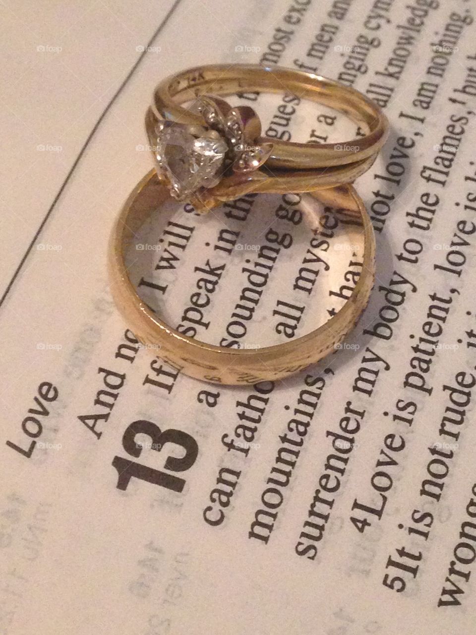 The greatest of these is love. Wedding rings on 1 Corinthians 13 in Bible