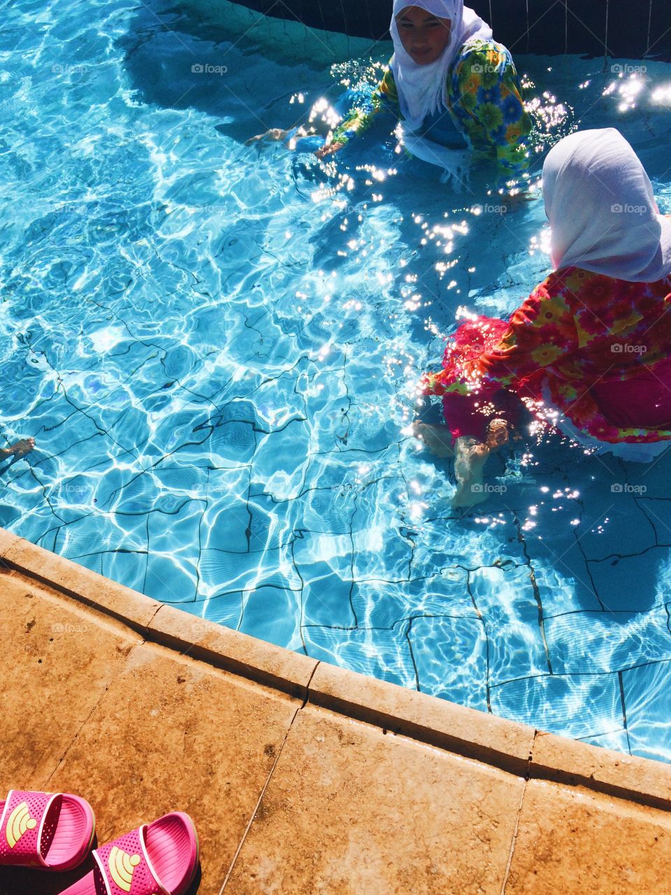 Women in hirable at swimming pool