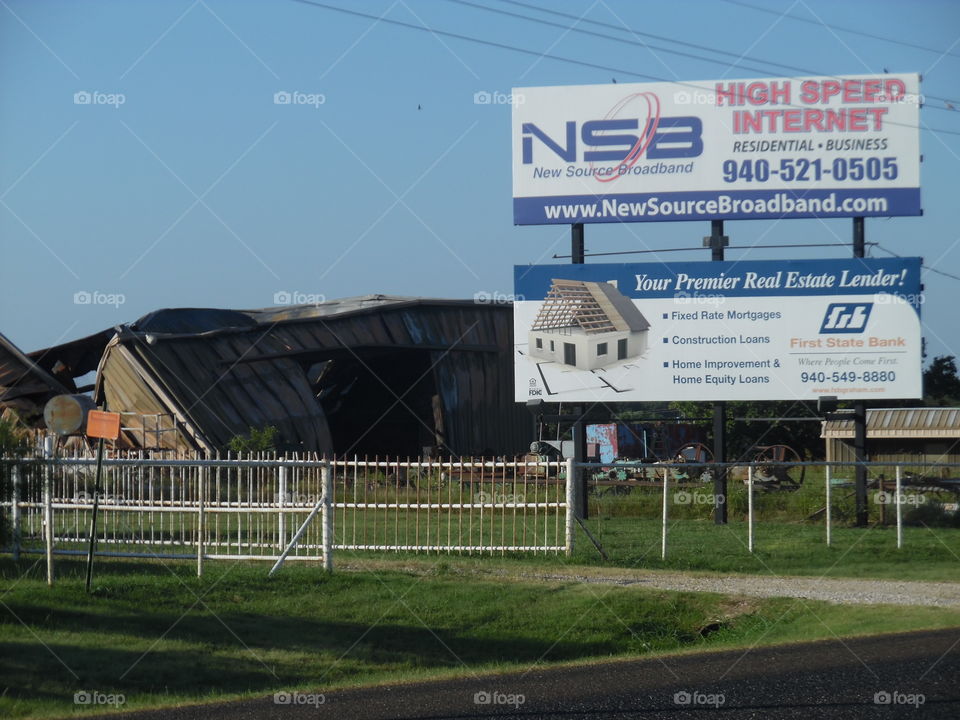 cash lender. This is a funny picture of a barn that has caved in right by a billboard advertising to loan money 💵