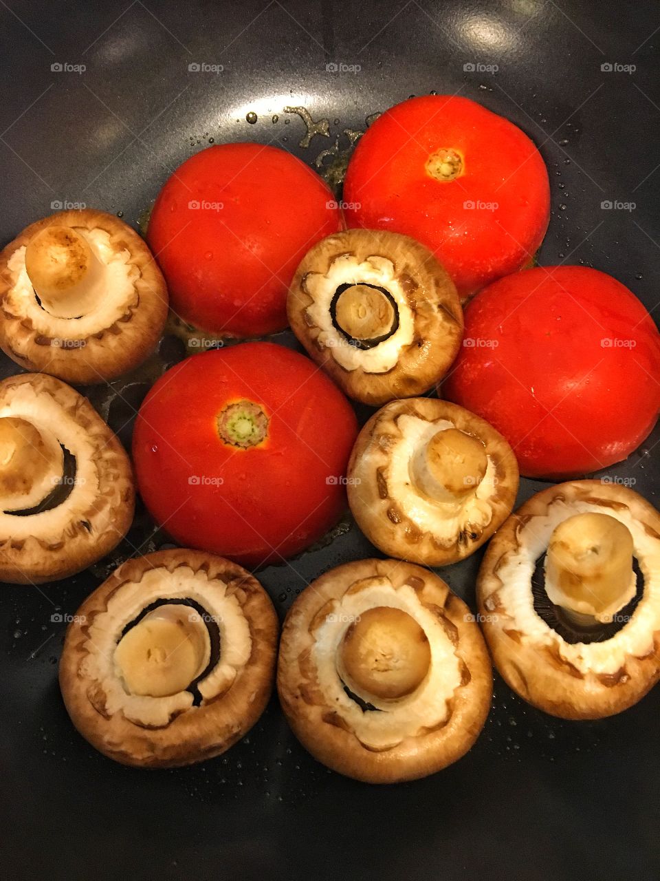 Tomatoes and mushrooms frying