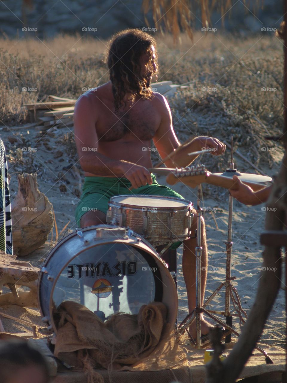 Drummer on the beach. Live band performing at a beach bar
