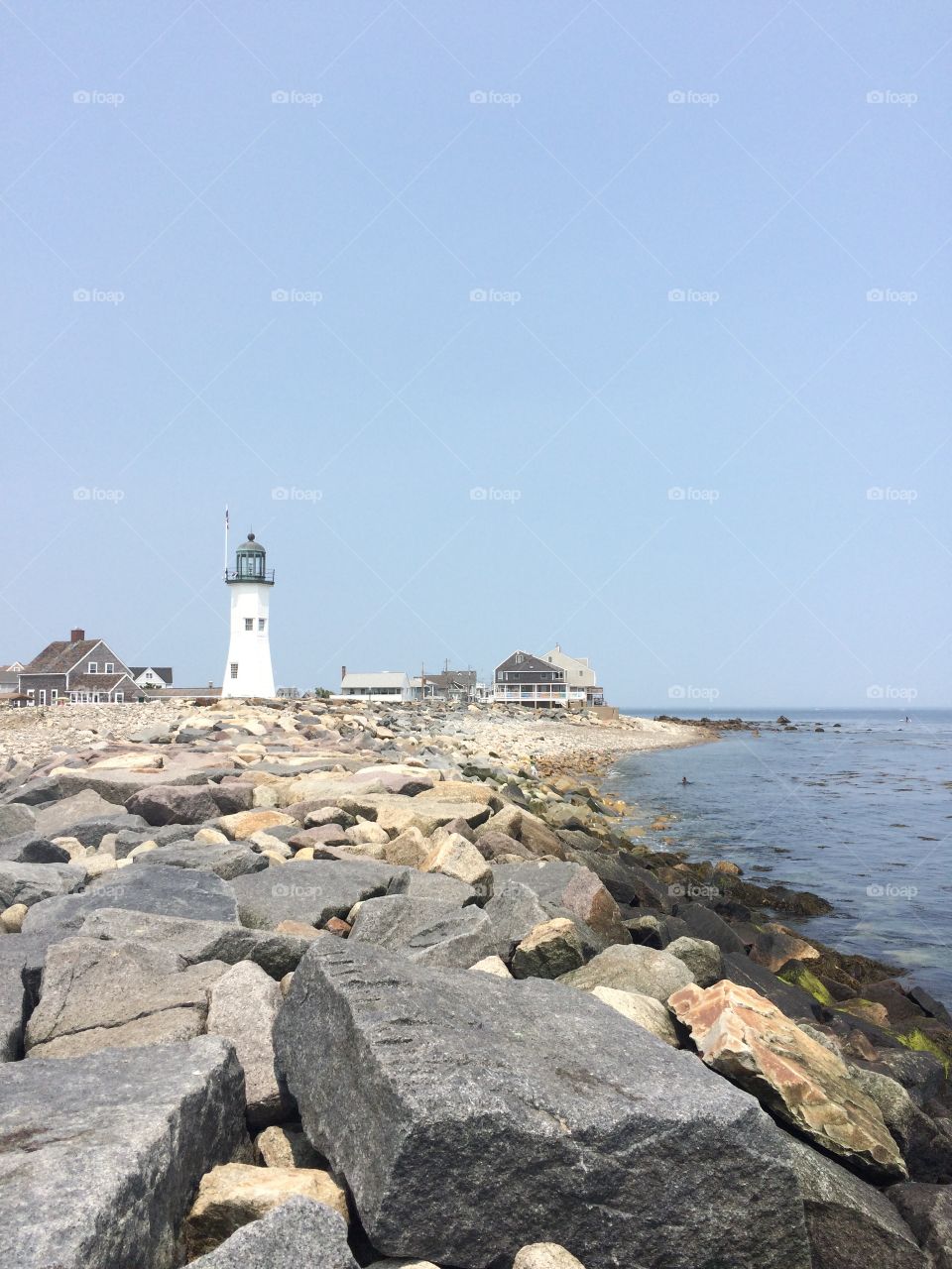 Scituate Lighthouse in July. Scituate lighthouse along the coastline in summer. 