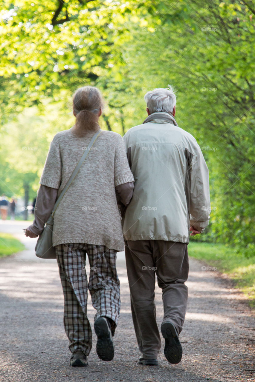 Old couple walking in the park