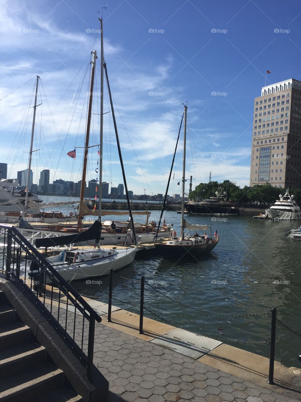 Downtown NYC harbor with small boats and yachts docked for the summer 