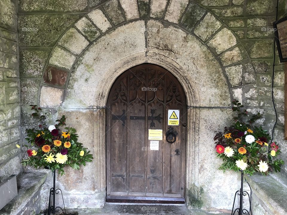 The entrance to St Pancras Church in Dartmoor, the floral presentations enhances this entrance very well.
