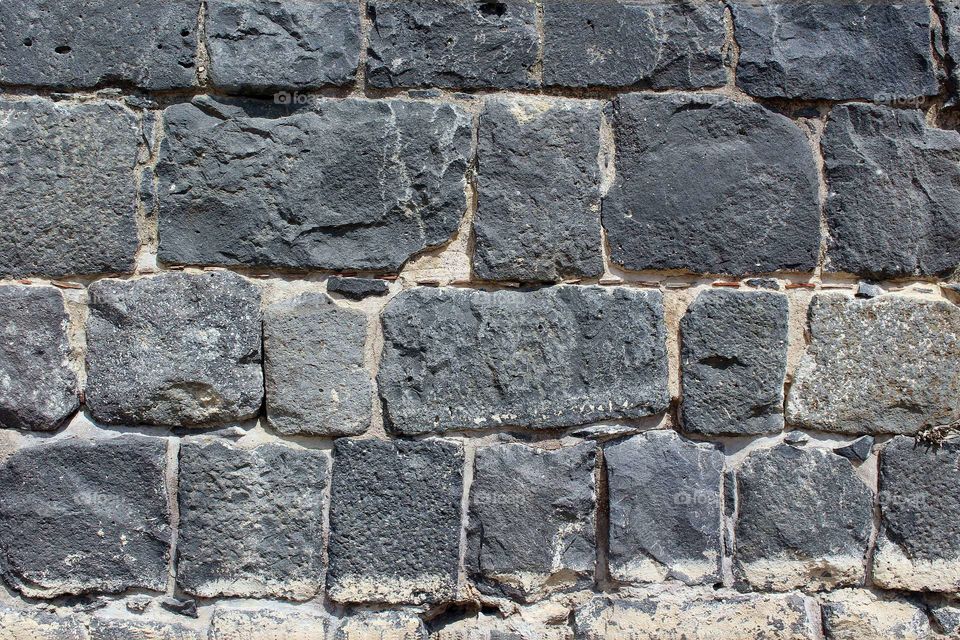 Texture of the stone wall. Dark granite as modern grunge design.