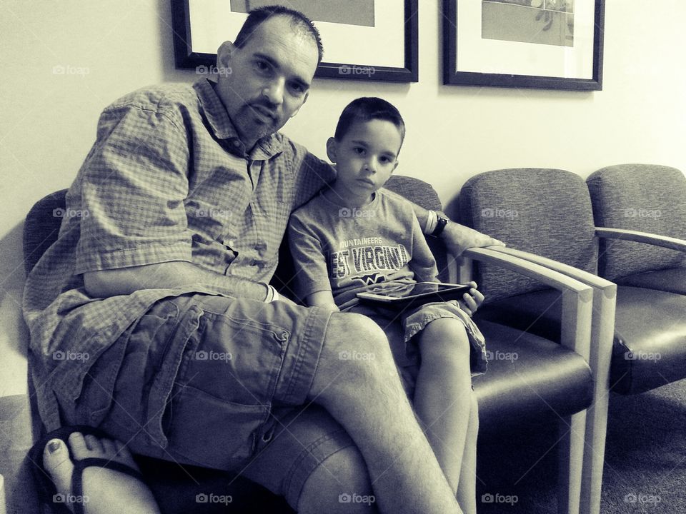 waiting room. dad waiting with son with CF for blood tests