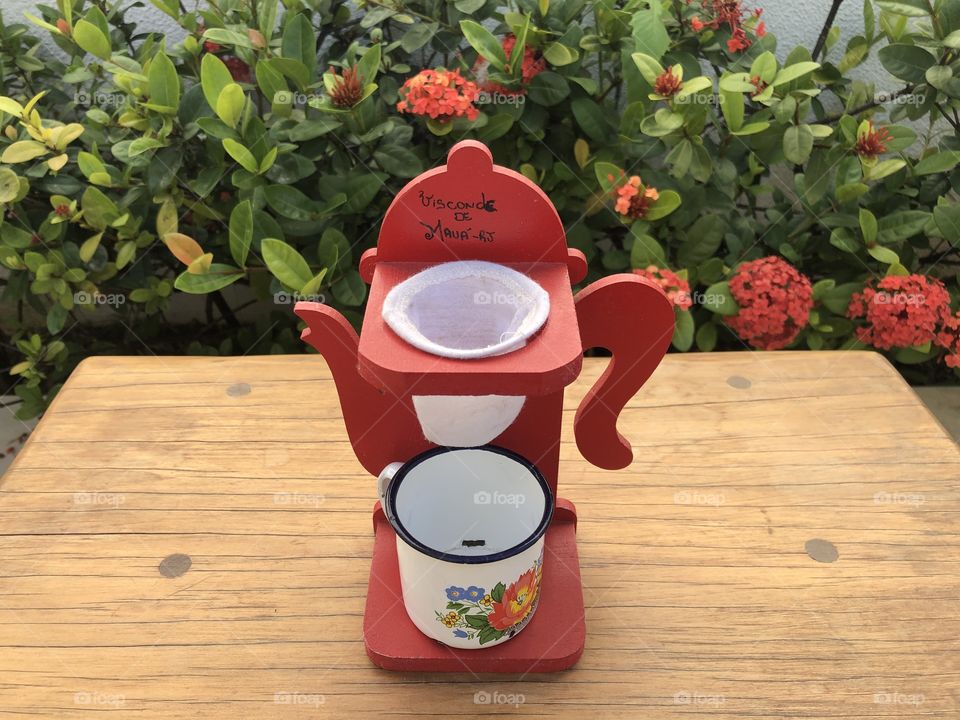 Coffee mug with flowers behind