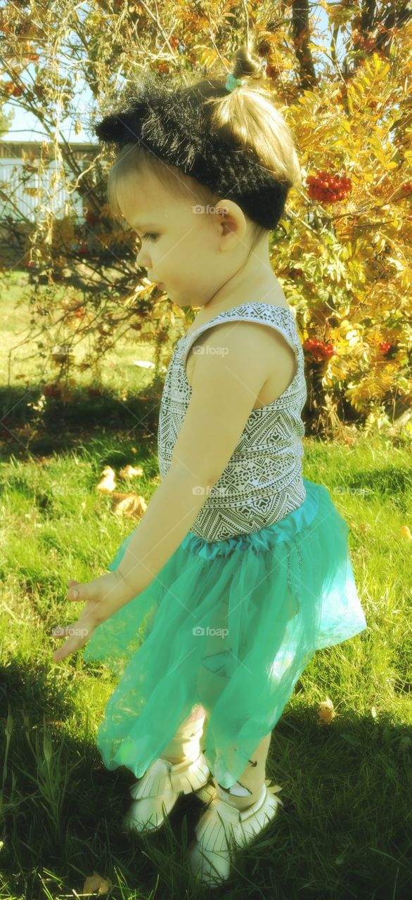 Small girl standing on grassy field