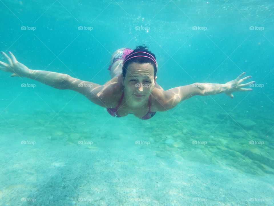 woman swimming underwater. woman swimming underwater towards camera